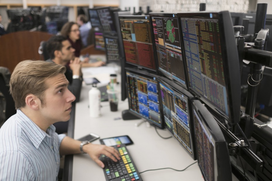 Young traders analyzing computer data